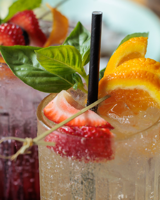 specialty mocktail with fresh fruit garnish